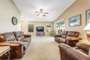 a living room with leather furniture and a flat screen tv at Good Times in Goodyear in Goodyear
