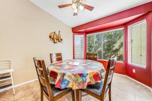 a dining room with a table and chairs and a ceiling fan at Good Times in Goodyear in Goodyear