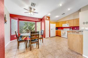 a kitchen with a table and chairs and a ceiling fan at Good Times in Goodyear in Goodyear