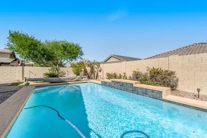 a swimming pool in the backyard of a house at Good Times in Goodyear in Goodyear