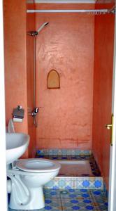 a bathroom with a shower with a toilet and a sink at Dar Omar Khayam in Tangier
