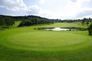a view of a golf course with a pond at B&F Hotel am Neumarkt in Bad Hersfeld