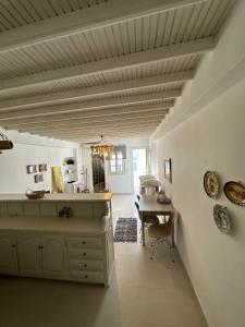 a hallway with a room with a table and a ceiling at Myconian Avra Apartment in Mikonos +5 photos