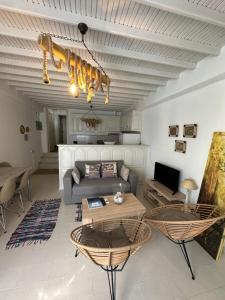 a living room with a couch and a table at Myconian Avra Apartment in Mikonos
