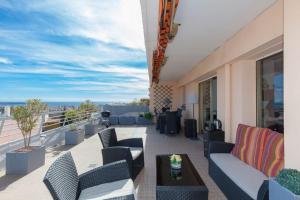 een balkon met stoelen en een tafel in een gebouw bij Studio vue mer panoramique sur la baie de Cannes in Le Cannet