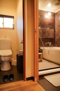 a bathroom with a toilet and a bath tub at 巡 in Osaka