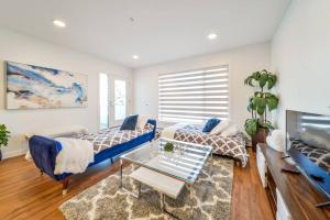 a living room with a couch and a table at Royal Blue Wild Oasis Corner PNHSE KingBed U/G Wi-fi in Edmonton