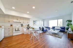 a kitchen and living room with a table and chairs at Royal Blue Wild Oasis Corner PNHSE KingBed U/G Wi-fi in Edmonton
