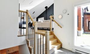 a staircase in a home with white walls and a window at 112 Chemin des Ruisselets in Stoneham