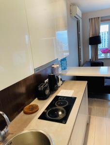 a kitchen with a sink and a stove top oven at City Centre Platinum Towers Apartment in Warsaw