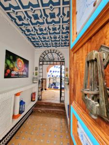 an entry way with a blue and white patterned ceiling at Arc House Mezquita - Only adults in Córdoba