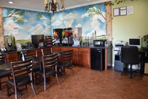 a bar in a restaurant with chairs and a counter at Platinum Inn Katy in Katy