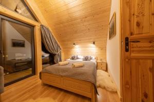 a bedroom with a bed in a tiny house at Domek Zakopiański Czar in Zakopane