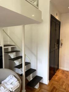 a spiral staircase in a room with a door at Ponte Milvio Smart Appartamento in Rome