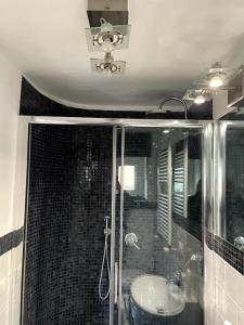 a bathroom with a glass shower with a sink at Ponte Milvio Smart Appartamento in Rome