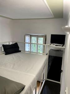 a bedroom with a bed and a desk with a computer at Ponte Milvio Smart Appartamento in Rome