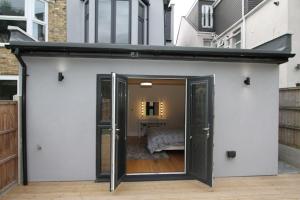 an open door to a bedroom in a house at Lovely One Bed Apartment-Near All Transport-Village-FreeParking in London