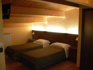 Un pat sau paturi într-o cameră la Residenza Sulla Roccia
