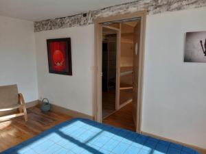 a bedroom with a door leading to a closet at Bâtisse historique proche Lac et forêts in Savères