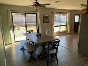 a dining room with a table and a ceiling fan at Sapphire Lake House* Boat Parking for 2 + Backyard in Page