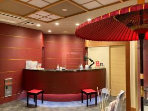 a waiting area with red walls and red stools at Kyoto Inn Gion The Second in Kyoto