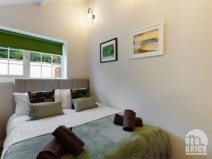 a bedroom with a bed and a window at The Lodge at Pickford House NEC and B'Ham Airport, Coventry in Coventry