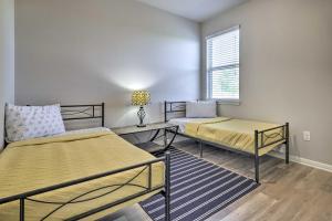 a room with two beds and a table and a window at Charming Buda Home about 19 Mi to Downtown Austin in Buda