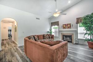 a living room with a couch and a fireplace at Glendale Oasis with Saltwater Pool and Hot Tub! in Phoenix