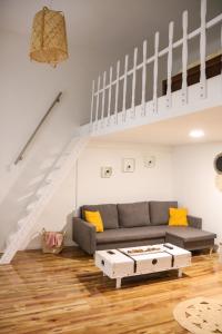 a living room with a couch and a coffee table at Budapest Avenue Apartment in Budapest