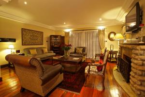 a living room with a couch and a fireplace at The Bedelle in Nairobi