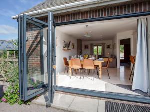 an extension to a house with a dining room and patio at Tokenhill Cottage in Piddletrenthide
