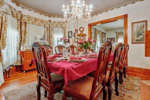 a dining room with a table and chairs and a chandelier at The Silk Pincushion in Golden