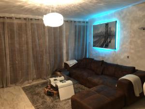 a living room with a brown couch and a blue light at Panorama Park, Punta Prima, 5 star Luxury 2 bedroom Apartment like no other in Alicante