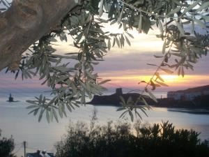 a view of a river with the sunset in the background at Vassiliki Studios in Andros