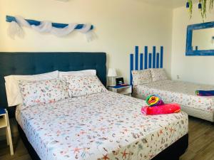 a bedroom with a bed with a stuffed animal on it at Tropical apartment in Cancún