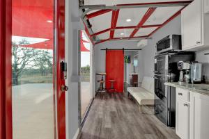 a kitchen and living room with a red door at Best little Fredericksburg Bed and Breakfast Unit2 in Fredericksburg