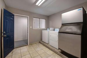 a kitchen with a refrigerator and white appliances at Motel 6-Sulphur Springs, TX in Sulphur Springs