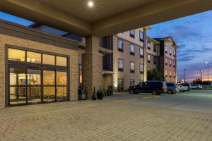 a building with cars parked in a parking lot at Best Western Plus North Platte Inn & Suites in North Platte