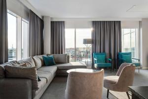 a living room with a couch and chairs at Best Western Plus Hotel Plaza in Västerås