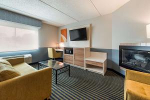 sala de estar con sofá y TV en Best Western Burlington Inn, en Westampton Township