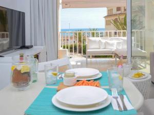 a table with plates and utensils on a table with a view at Bonita stay B Rocks Nuevo vistas fibra clima in Jávea
