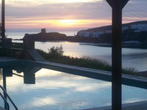 a reflection of a sunset in a body of water at Vassiliki Studios in Andros