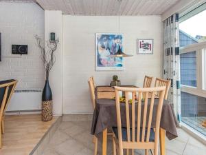 a dining room with a table and chairs at 5 person holiday home in Henne in Henne Strand