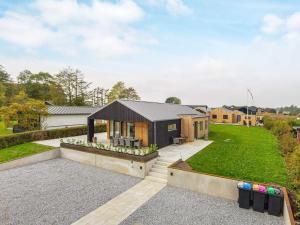 a contemporary house with a black roof at Holiday home Haderslev XLVII in Haderslev