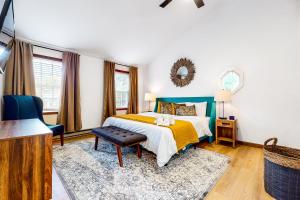 a bedroom with a bed with a yellow and white blanket at Tree and Easy in Tobyhanna