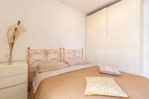 a bedroom with a large bed with two pillows on it at Apartment Holiday Senigallia in Senigallia