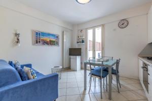 a living room with a blue couch and a table at Apartment Holiday Senigallia in Senigallia