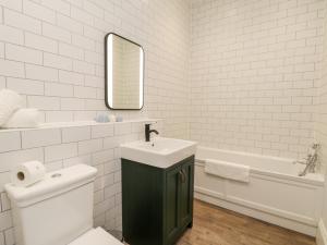 a bathroom with a sink and a toilet and a tub at Saltern Suite in Saltburn-by-the-Sea +31 photos