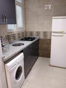 a kitchen with a sink and a washing machine at TWO ROOMS WITH KITCHEN in Istanbul