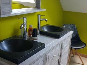a bathroom with a black sink and two faucets at Gîte de charme avec SPA et cheminée, près du Mans, 7 chambres, WIFI, en bord de forêt de Vibraye - FR-1-410-308 in Dollon +19 photos